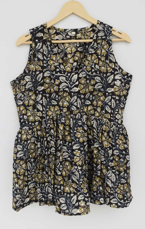 black, gold, and white hand-block printed, floral or leaf pattern, cotton sleeveless peplum top.