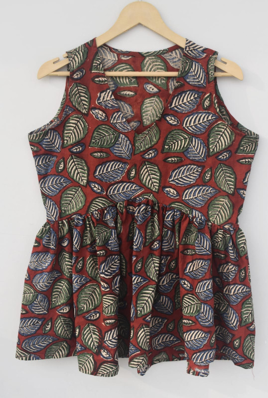 a reddish-brown, green,  leaf pattern, cotton sleeveless peplum top.