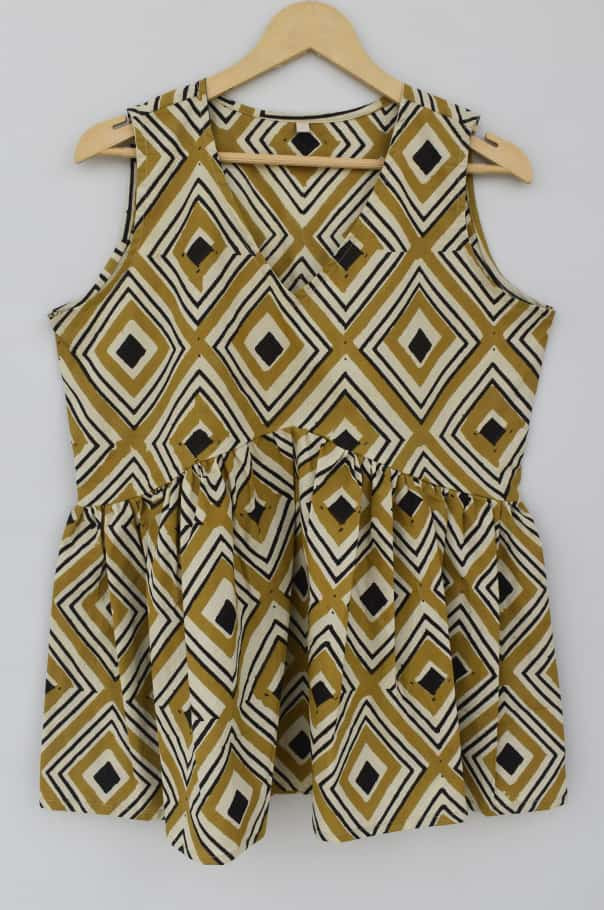 Mustard yellow, black, and off-white geometric diamond pattern cotton sleeveless peplum top.