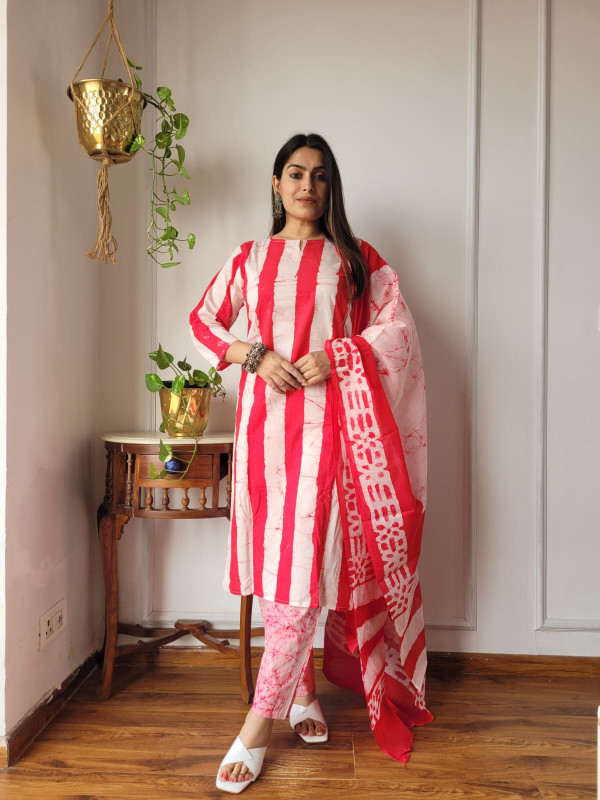red and white hand block printed or tie-dye cotton kurta, pants, and dupatta suit set