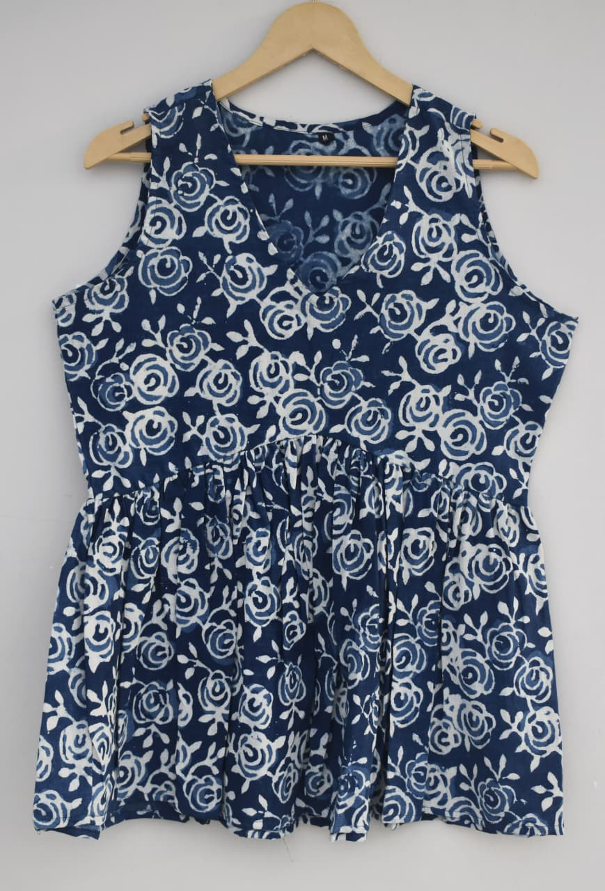 Blue, hand-block printed, cotton, sleeveless peplum top with a white floral or rose pattern.