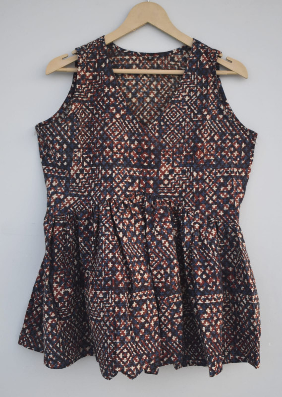 dark blue, reddish-brown, and off-white abstract or geometric pattern cotton sleeveless peplum top