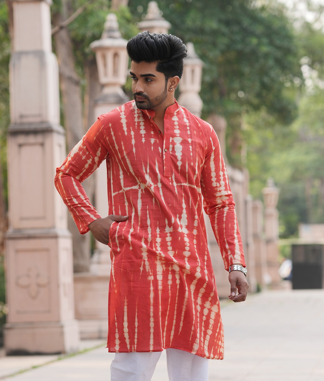 Coral red with a tie-dye or leheriya print pattern.