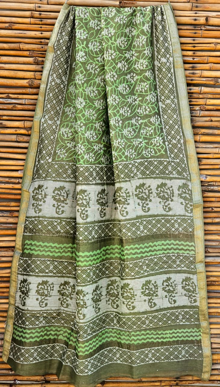 green and white hand-block printed Maheshwari or Chanderi silk/cotton blend saree with traditional motifs and a golden zari border