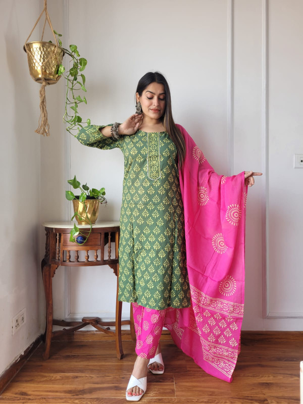 green and hot pink hand block printed cotton kurta, pants, and dupatta suit set.