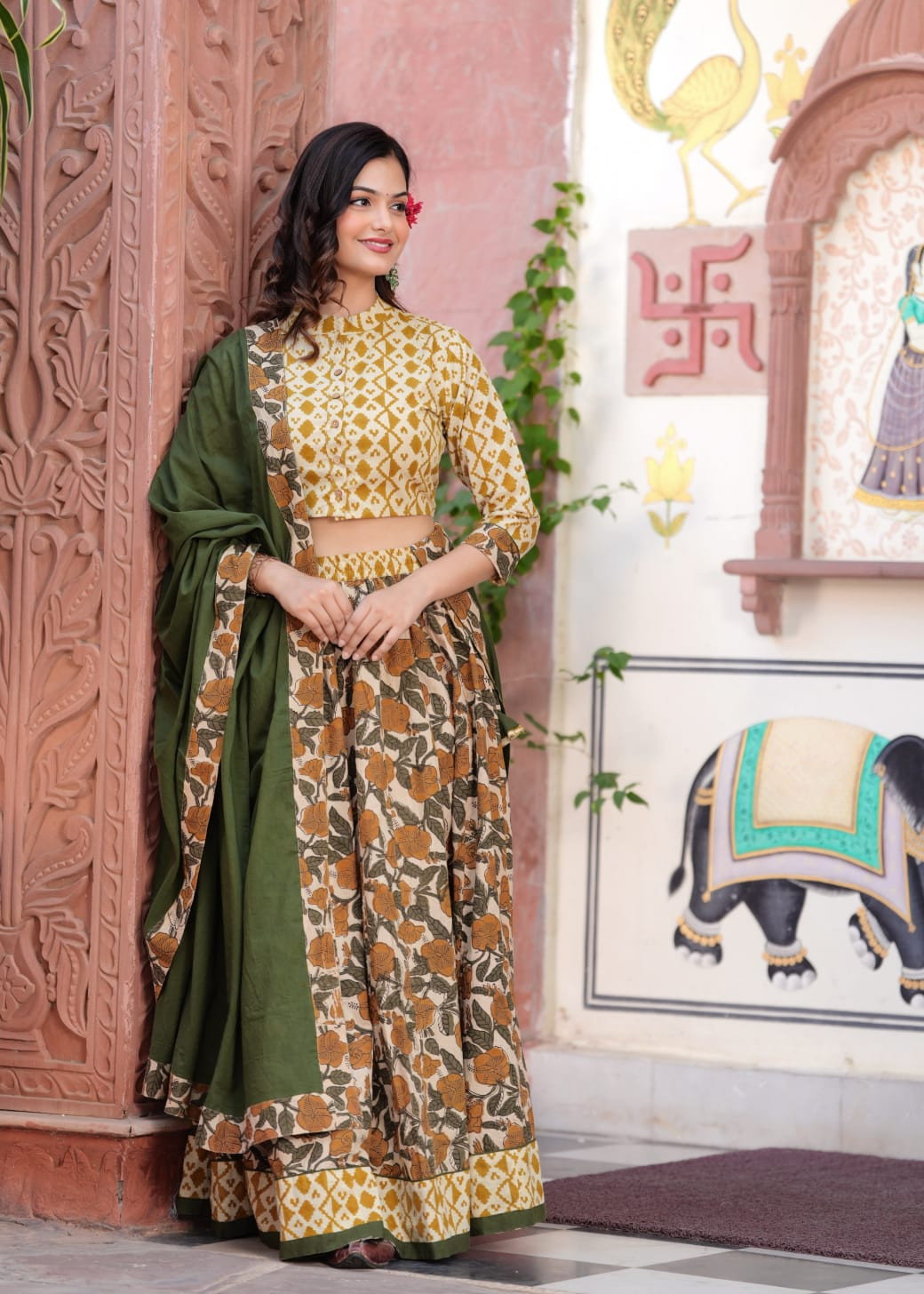 Mustard Yellow Geometric and Floral Printed Cotton Lehenga Choli with a Solid Olive Green Dupatta.