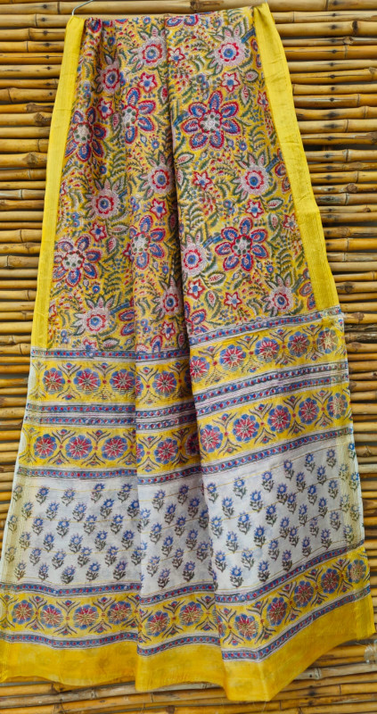 yellow hand-block printed silk-cotton blend chanderi or maheshwari saree with a blue and red border.