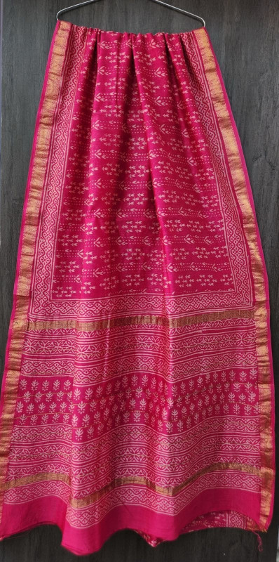 pink hand-block printed Maheshwari silk/cotton blend saree with traditional motifs and a golden zari border.