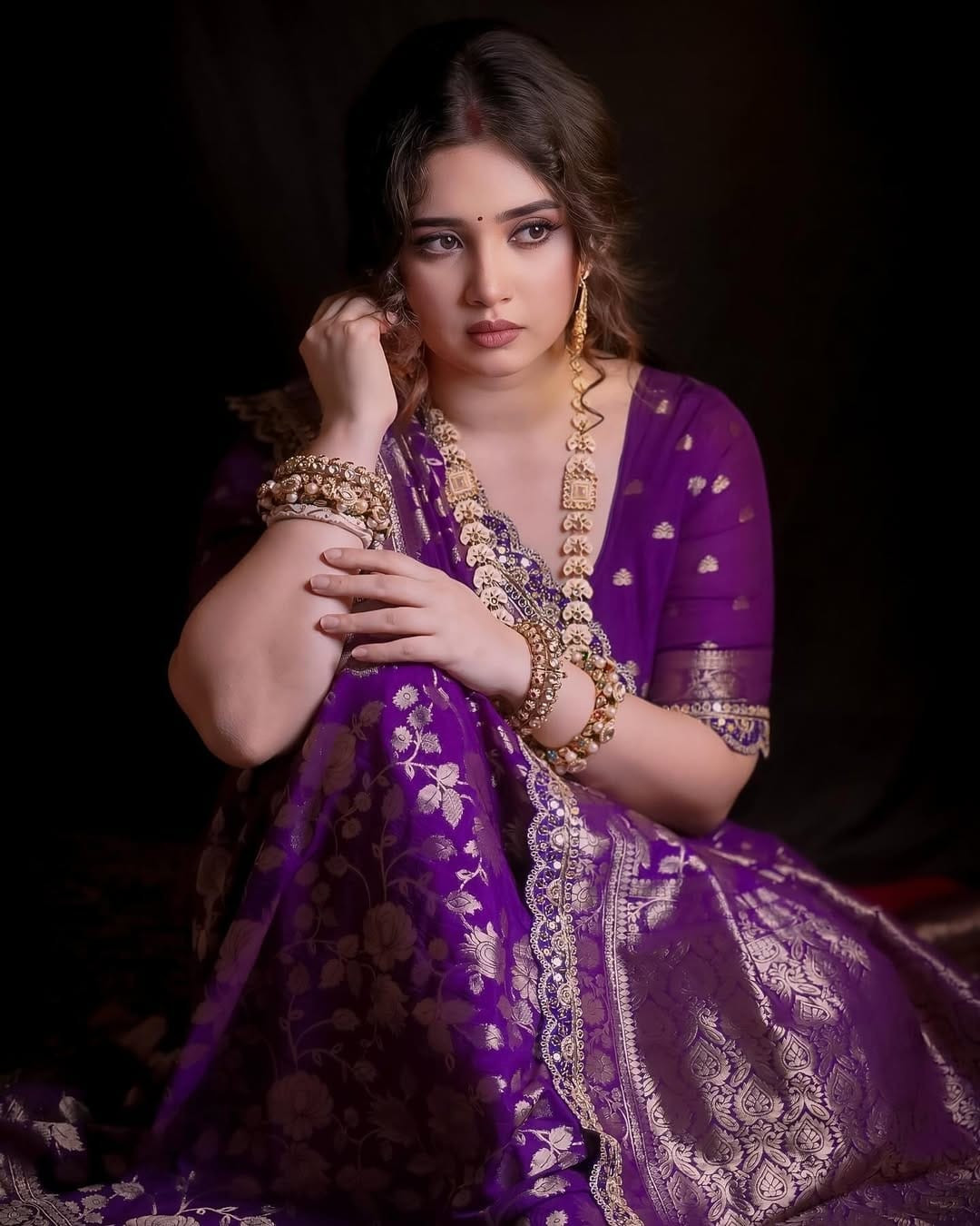 Purple and gold saree, made using khaddi georgette  weaving technique with a floral design.