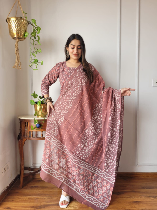 green and hot pink hand block printed cotton kurta, pants, and dupatta suit set.