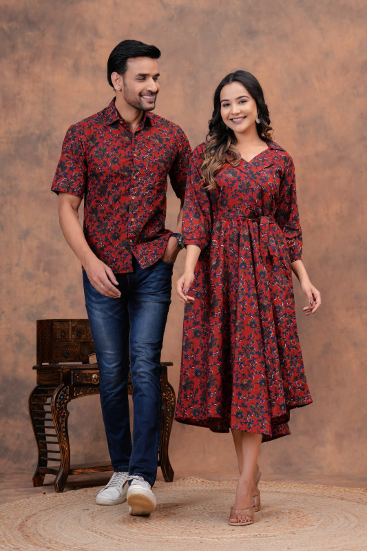A matching couple's outfit in a red and black floral print design