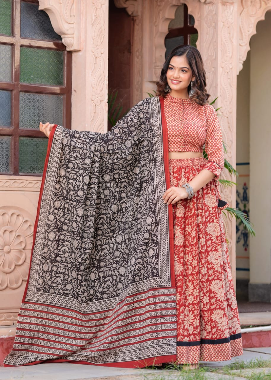 Red Floral Ajrakh Printed Cotton Lehenga Choli with a Contrast Black Botanical Print Dupatta.