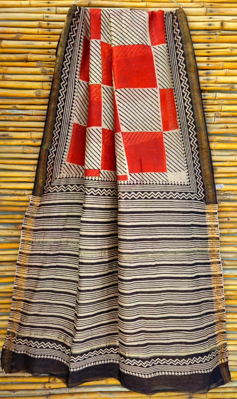 Black and white striped Maheshwari silk cotton blend saree with a red and white printed checkered pallu and gold zari border.